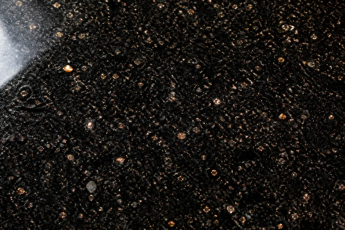 Polished Black Galaxy granite with copper and gold flecks